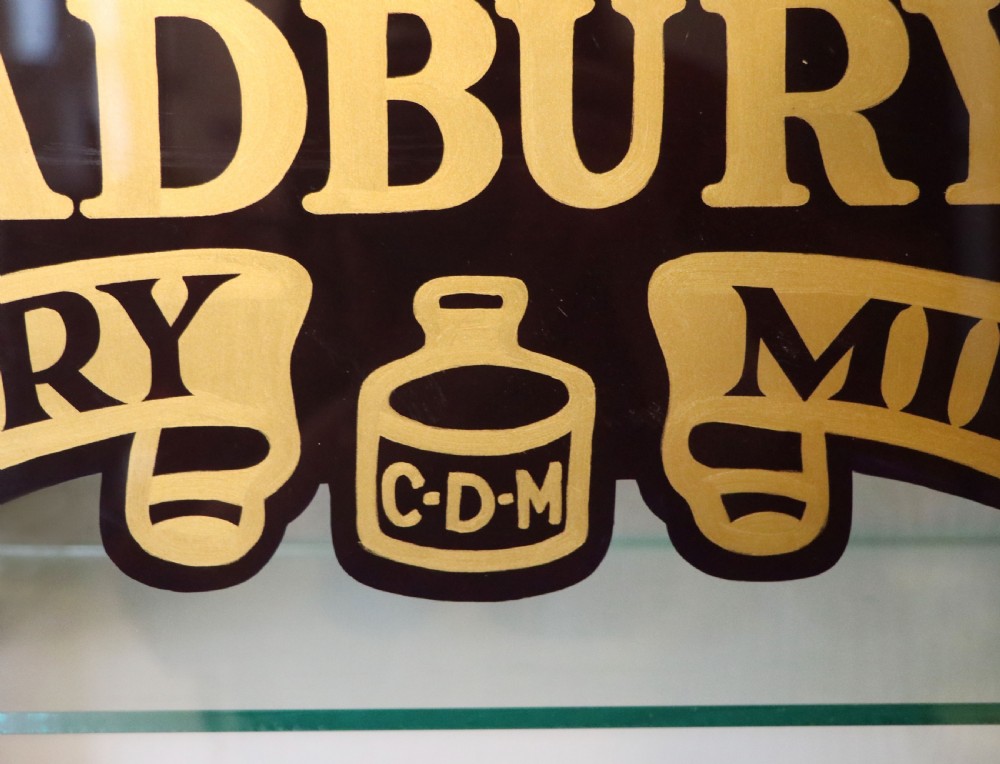 A lovely mahogany framed wall mounted display cabinet hand sign written for Cadburys Chocolate View X