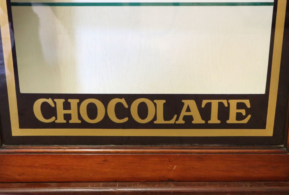A lovely mahogany framed wall mounted display cabinet hand sign written for Cadburys Chocolate View XI