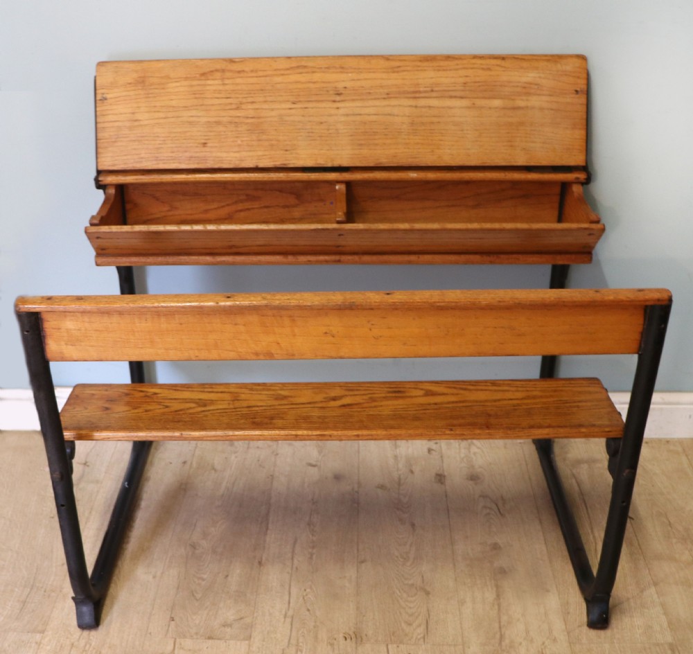 A wonderful early 20th century oak and iron framed school desk and integral chair.  View III