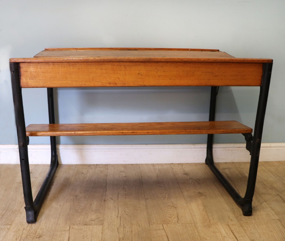 A wonderful early 20th century oak and iron framed school desk and integral chair.  View II
