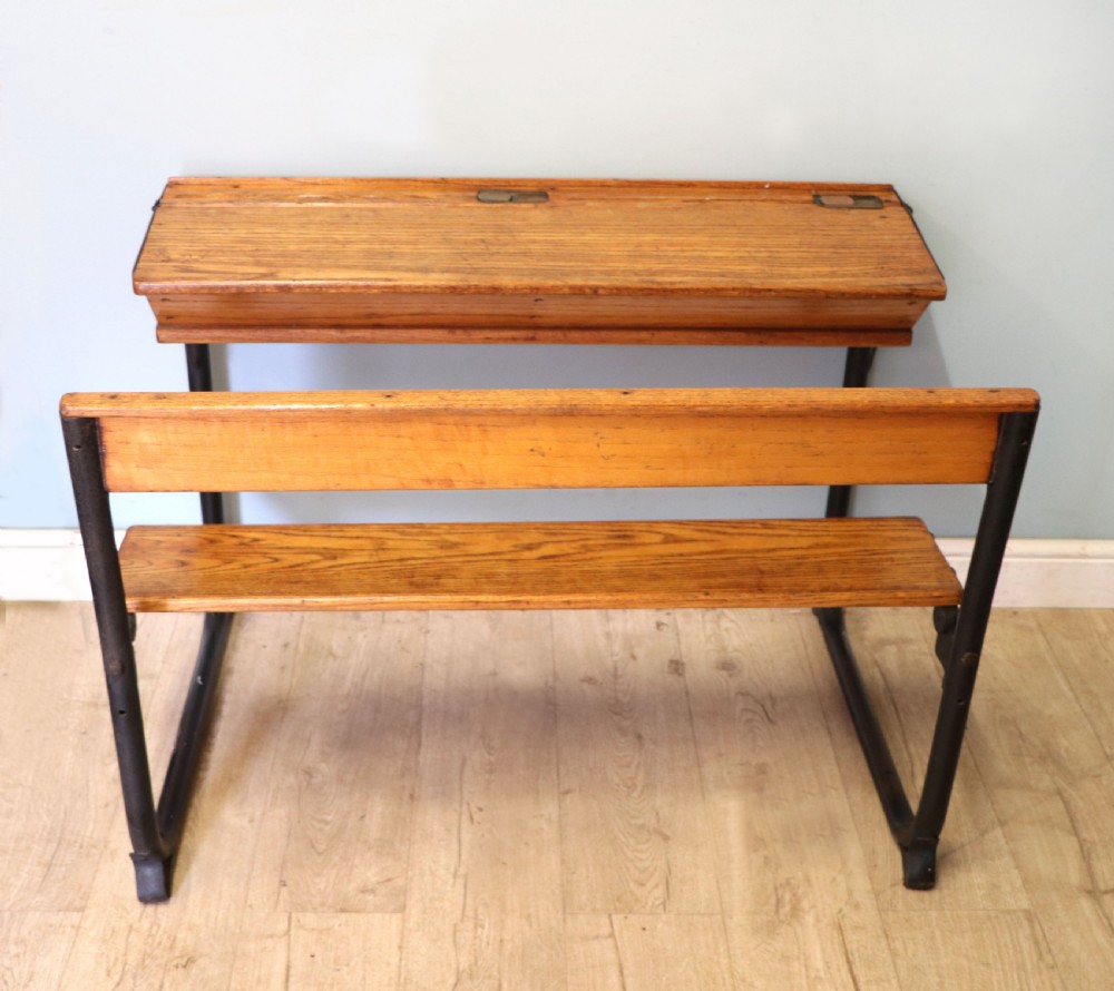 A wonderful early 20th century oak and iron framed school desk and integral chair. 