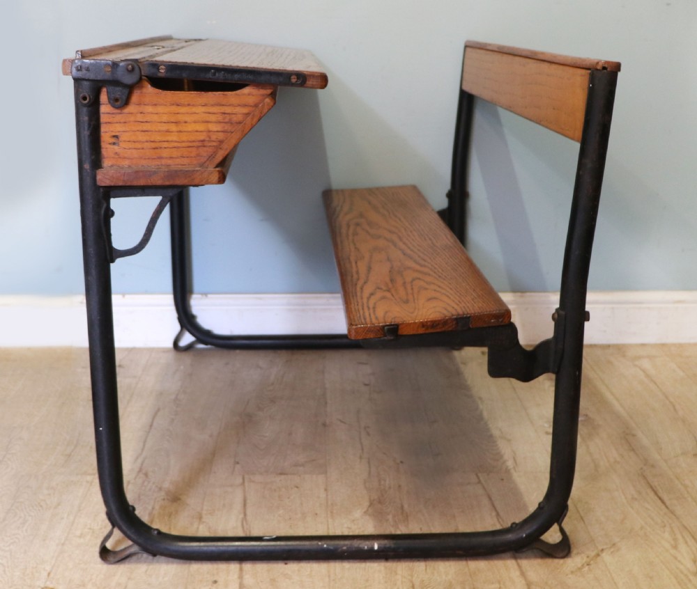 A wonderful early 20th century oak and iron framed school desk and integral chair.  View VII