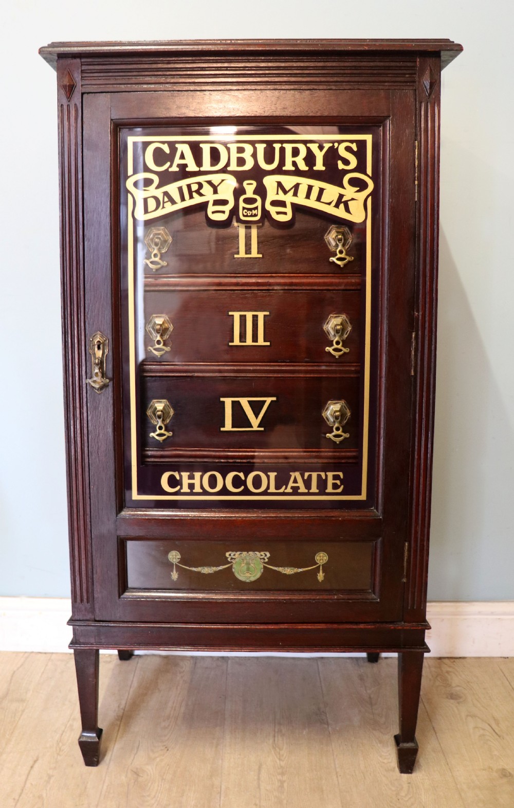 A lovely dark mahogany cabinet hand sign written for Cadburys chocolate.