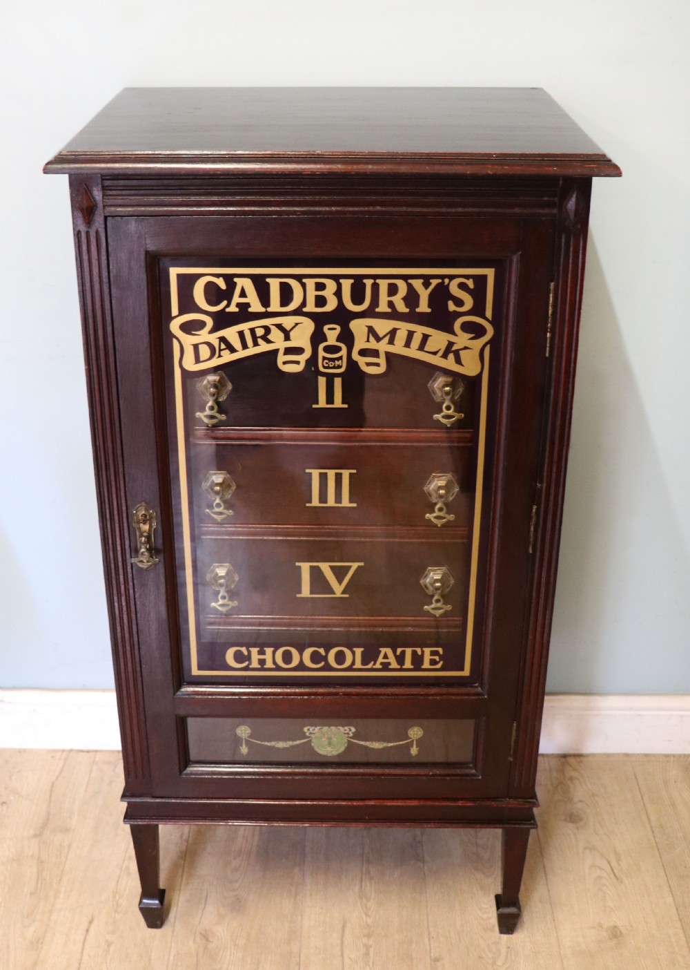 A lovely dark mahogany cabinet hand sign written for Cadburys chocolate. View II