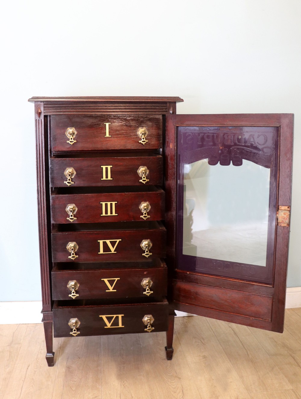 A lovely dark mahogany cabinet hand sign written for Cadburys chocolate. View IV