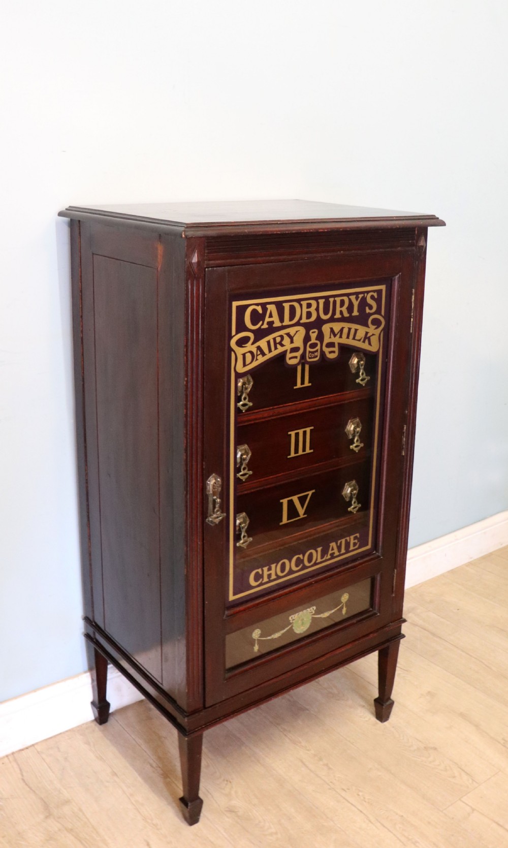 A lovely dark mahogany cabinet hand sign written for Cadburys chocolate. View V