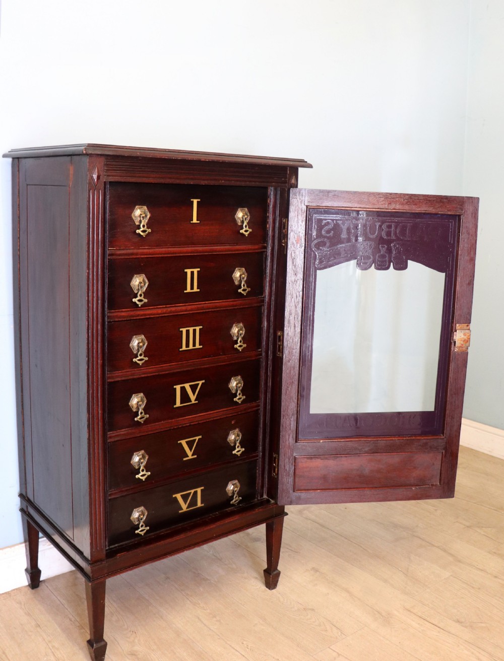 A lovely dark mahogany cabinet hand sign written for Cadburys chocolate. View VI