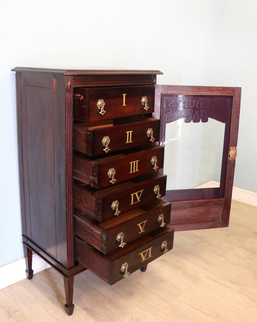 A lovely dark mahogany cabinet hand sign written for Cadburys chocolate. View VII