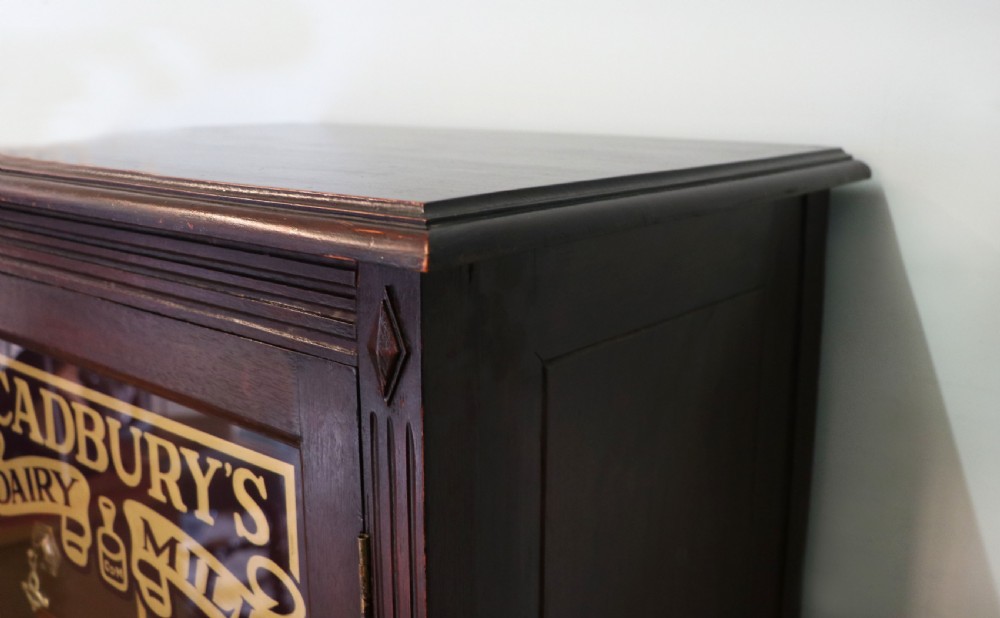 A lovely dark mahogany cabinet hand sign written for Cadburys chocolate. View XIII