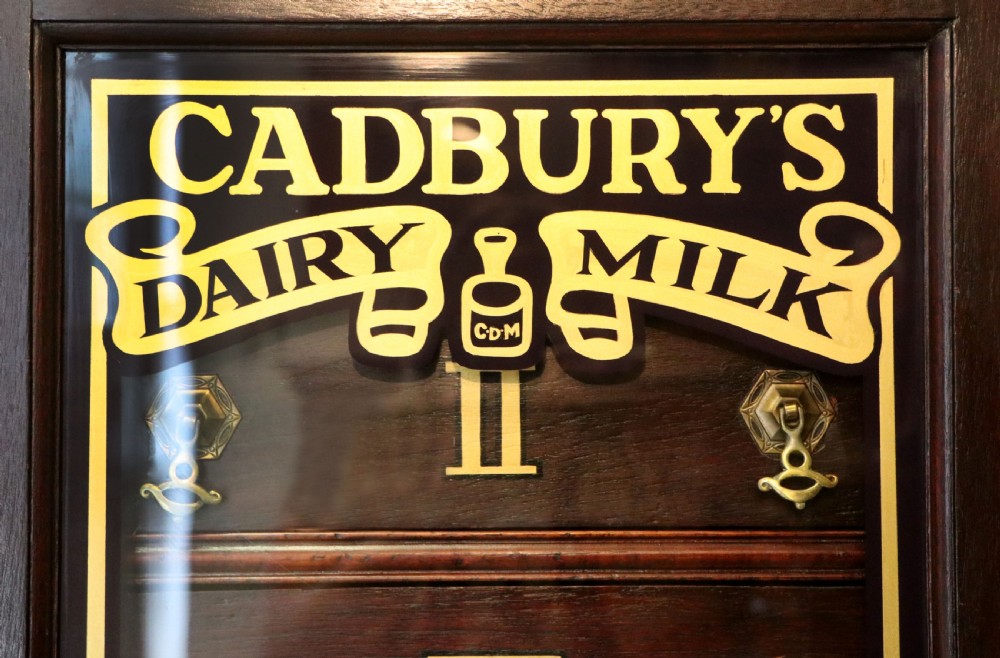 A lovely dark mahogany cabinet hand sign written for Cadburys chocolate. View XIV