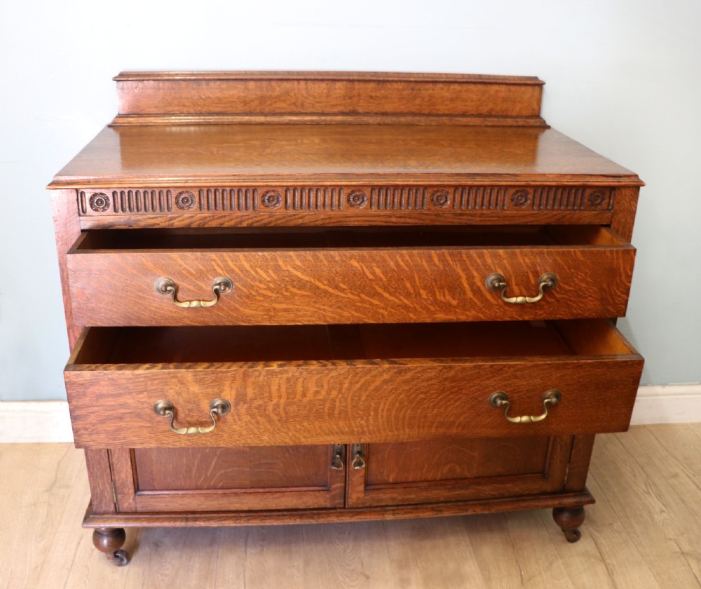 A Edwardian oak combination chest and cupboard. View II