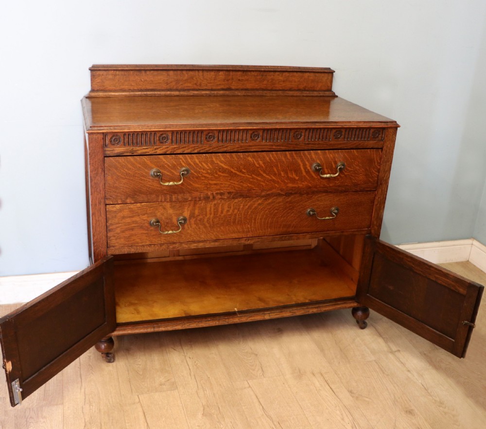 A Edwardian oak combination chest and cupboard. View III