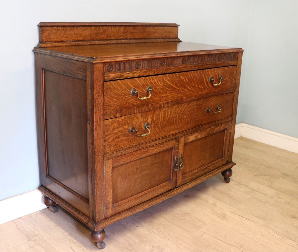 A Edwardian oak combination chest and cupboard. View IV