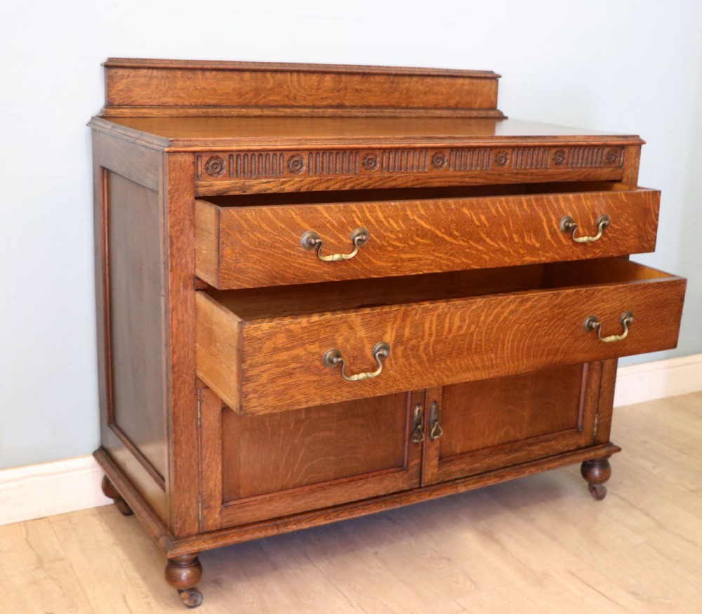 A Edwardian oak combination chest and cupboard. View V