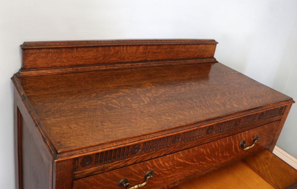 A Edwardian oak combination chest and cupboard. View VI