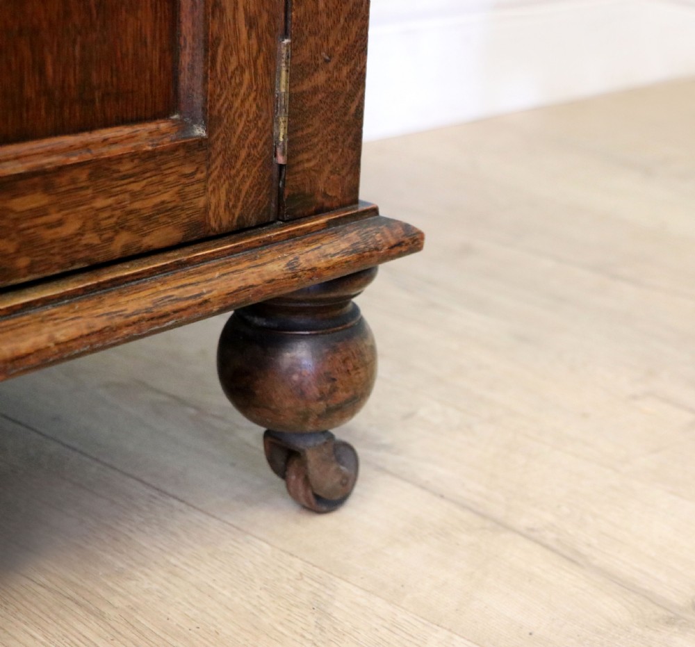 A Edwardian oak combination chest and cupboard. View IX
