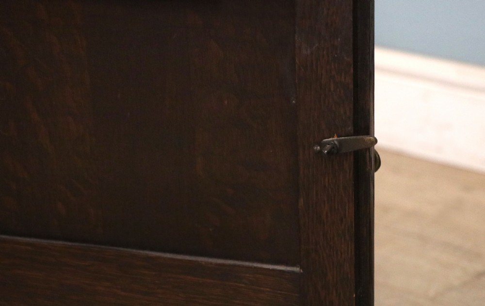 A Edwardian oak combination chest and cupboard. View XI