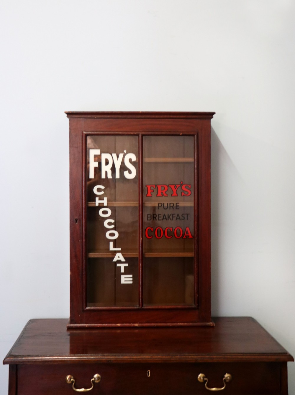 A 19th century mahogany shop display cabinet later sign written for Fry’s cocoa. View II