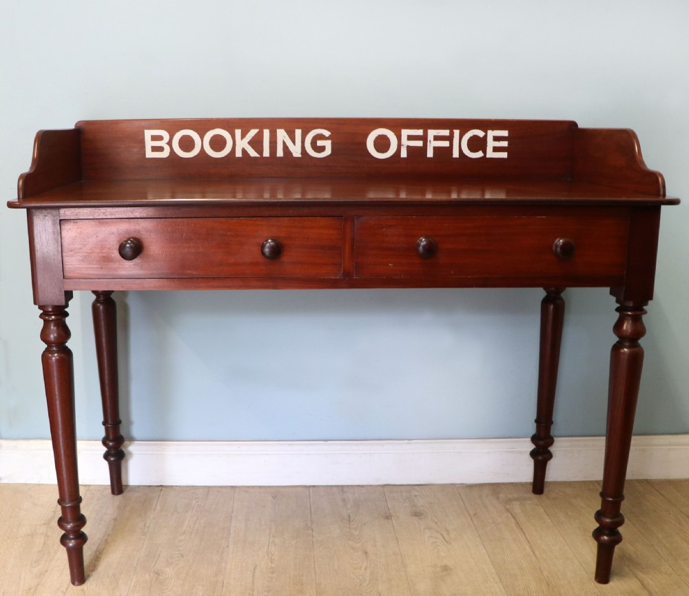A lovely Victorian mahogany table later sign written booking office.