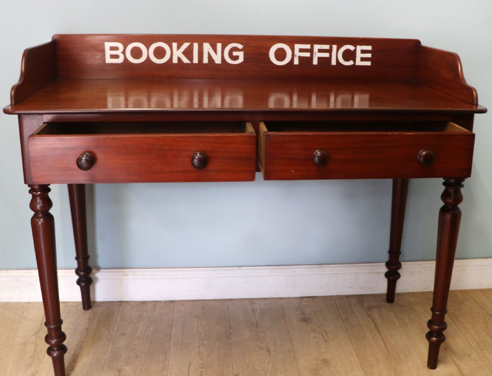 A lovely Victorian mahogany table later sign written booking office. View II