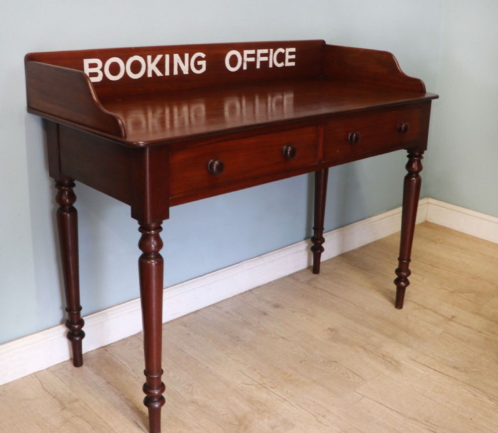 A lovely Victorian mahogany table later sign written booking office. View III