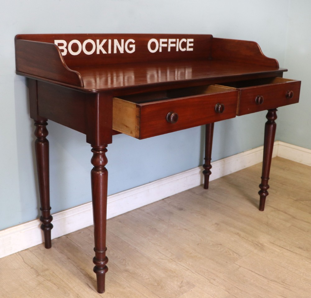 A lovely Victorian mahogany table later sign written booking office. View IV