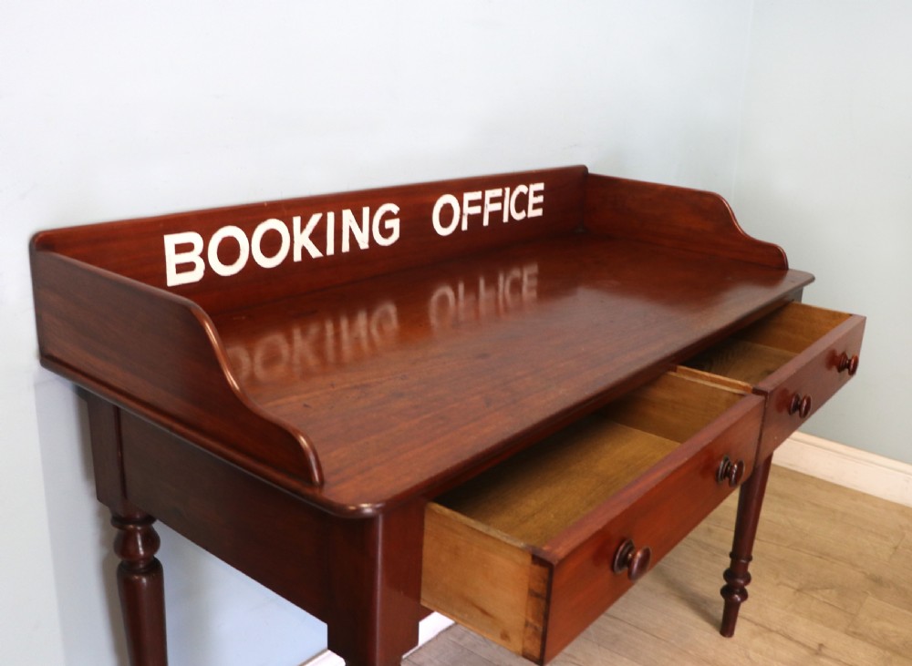 A lovely Victorian mahogany table later sign written booking office. View VIII