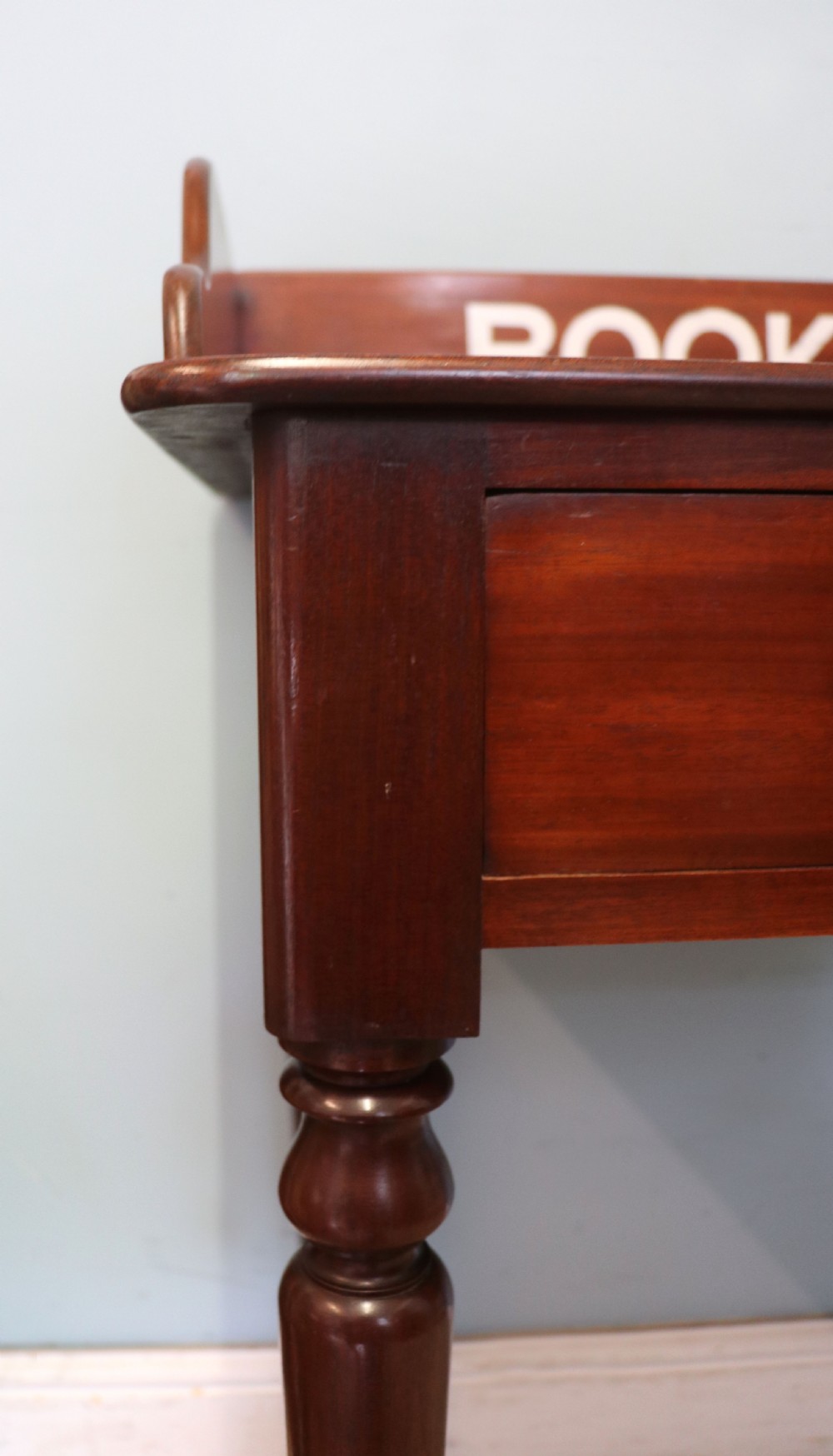 A lovely Victorian mahogany table later sign written booking office. View XI