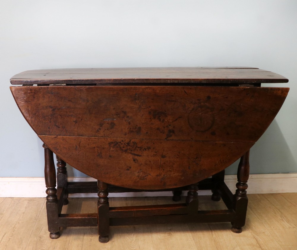 A lovely 18th century English oak drop leaf dining table. View II