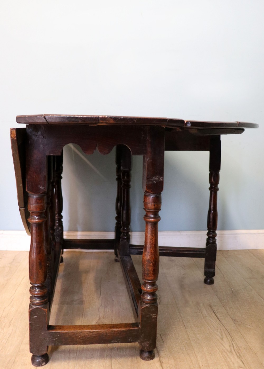 A lovely 18th century English oak drop leaf dining table. View III