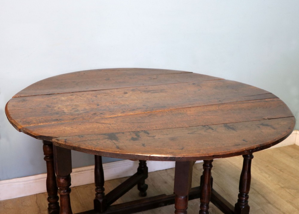 A lovely 18th century English oak drop leaf dining table. View V