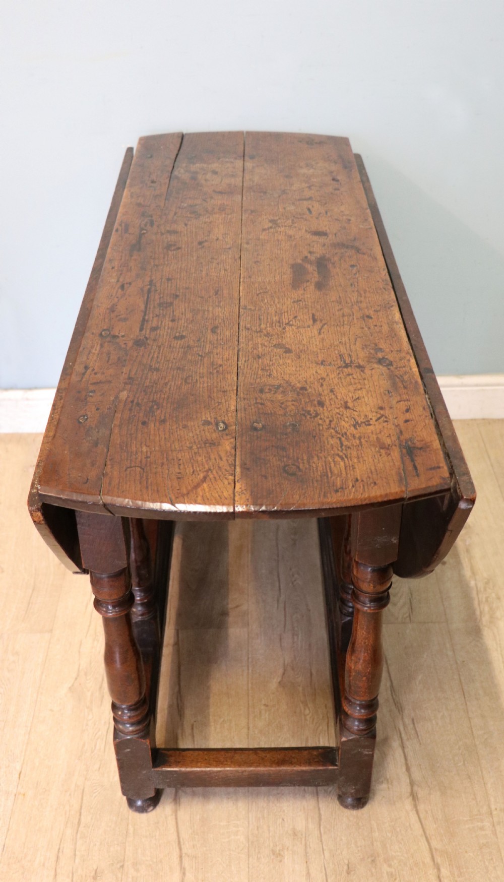 A lovely 18th century English oak drop leaf dining table. View VI