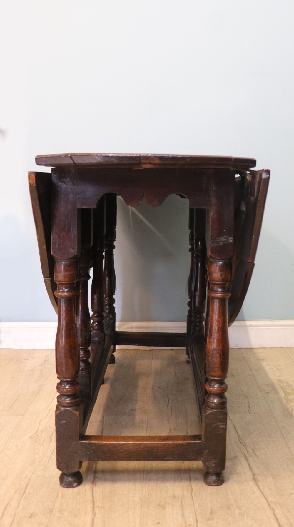 A lovely 18th century English oak drop leaf dining table. View VII