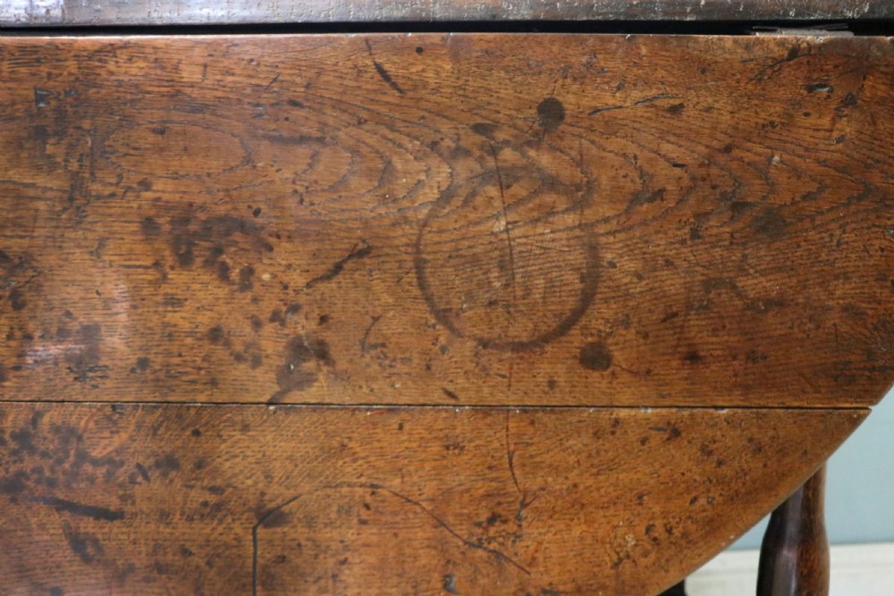 A lovely 18th century English oak drop leaf dining table. View XI