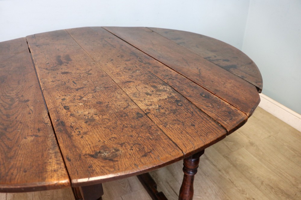 A lovely 18th century English oak drop leaf dining table. View XIII