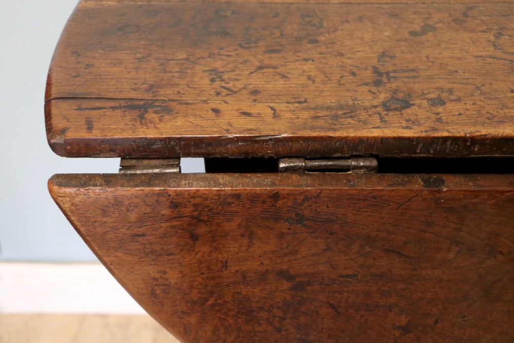 A lovely 18th century English oak drop leaf dining table. View XV