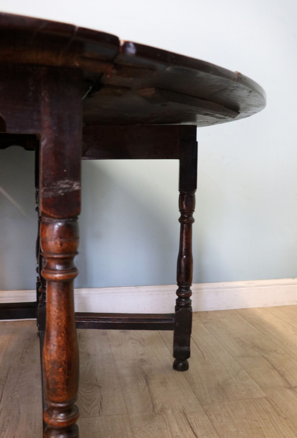 A lovely 18th century English oak drop leaf dining table. View XVII