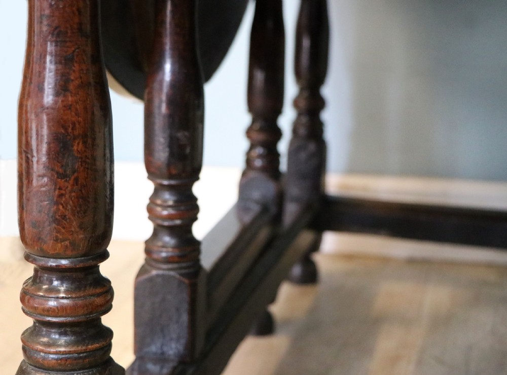 A lovely 18th century English oak drop leaf dining table. View XX