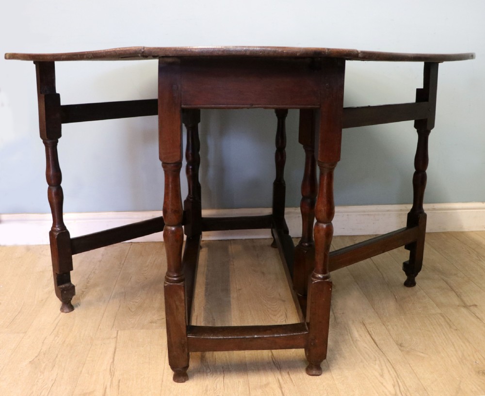 A lovely 18th century English oak drop leaf dining table.  View VI