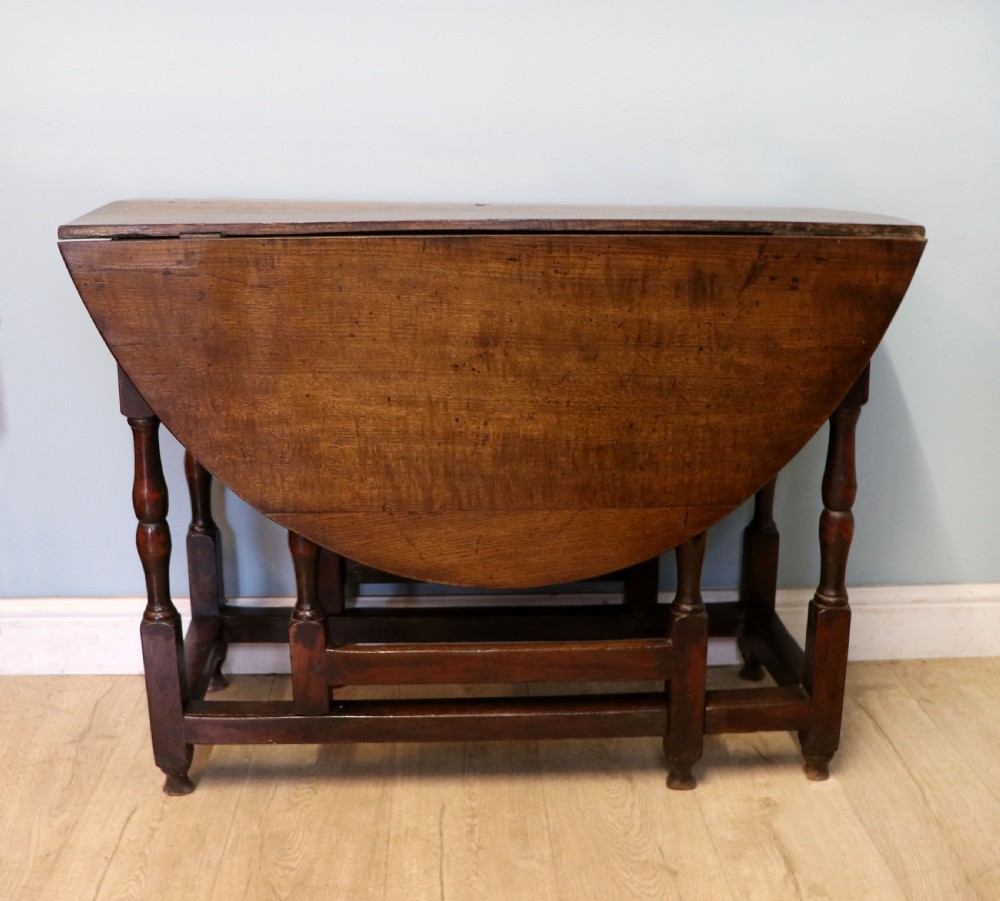 A lovely 18th century English oak drop leaf dining table.  View II