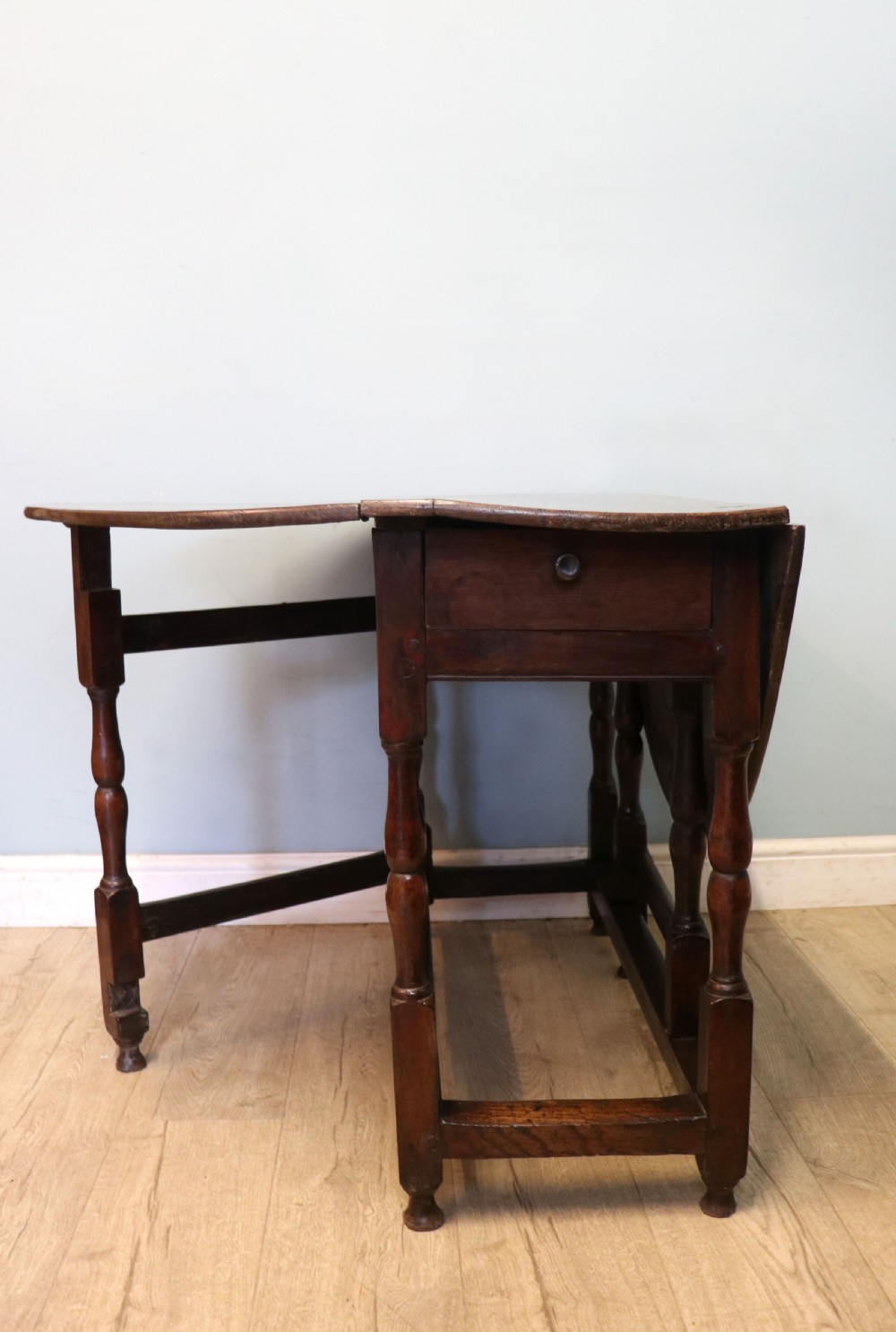 A lovely 18th century English oak drop leaf dining table.  View III