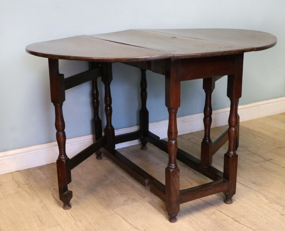 A lovely 18th century English oak drop leaf dining table.  View IV