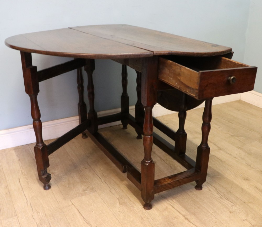 A lovely 18th century English oak drop leaf dining table.  View V