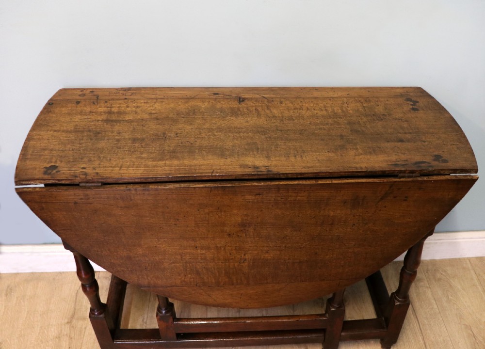 A lovely 18th century English oak drop leaf dining table.  View VIII