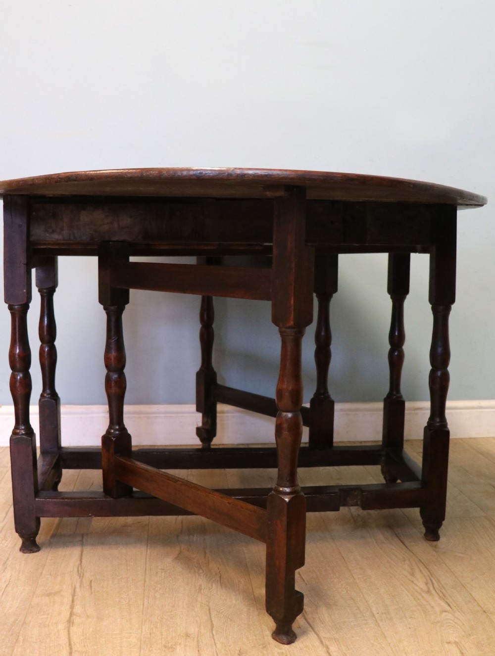 A lovely 18th century English oak drop leaf dining table.  View IX