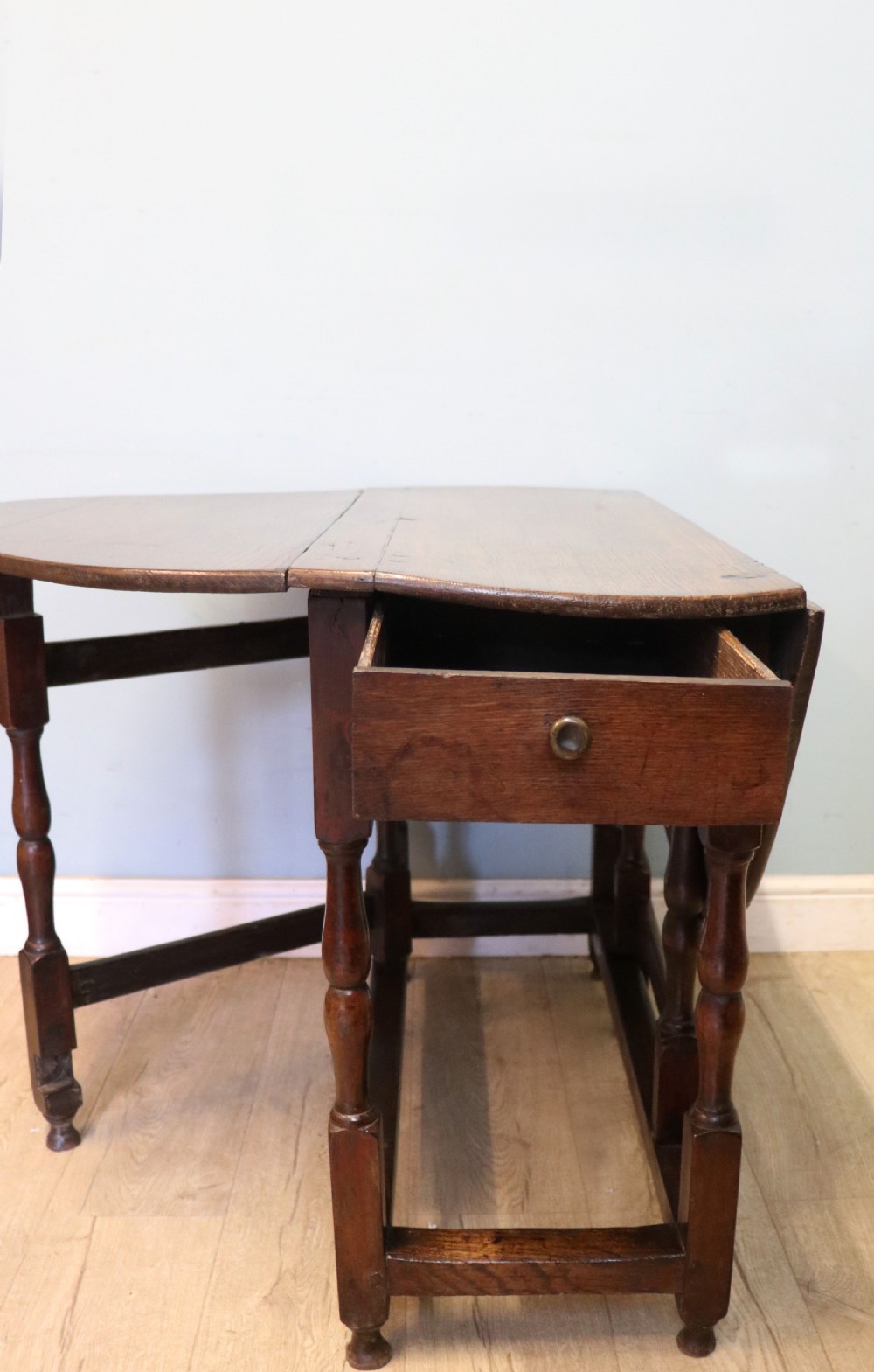 A lovely 18th century English oak drop leaf dining table.  View X