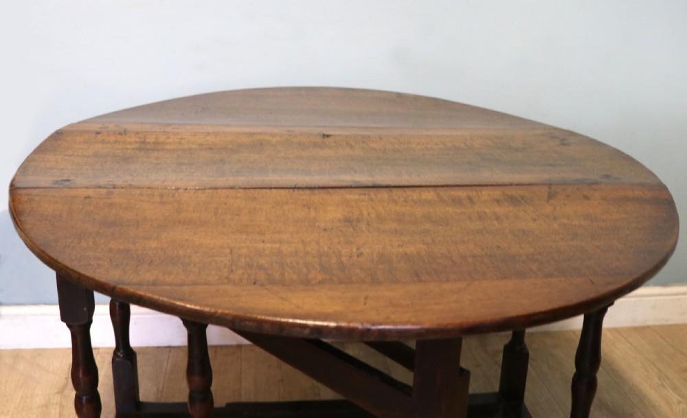 A lovely 18th century English oak drop leaf dining table.  View XIV