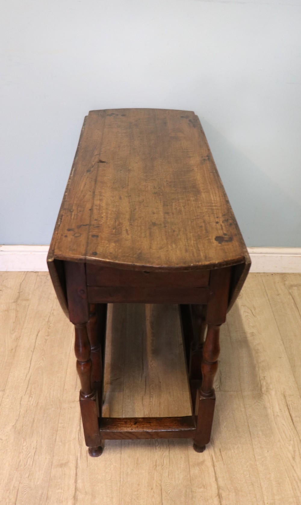 A lovely 18th century English oak drop leaf dining table.  View XV