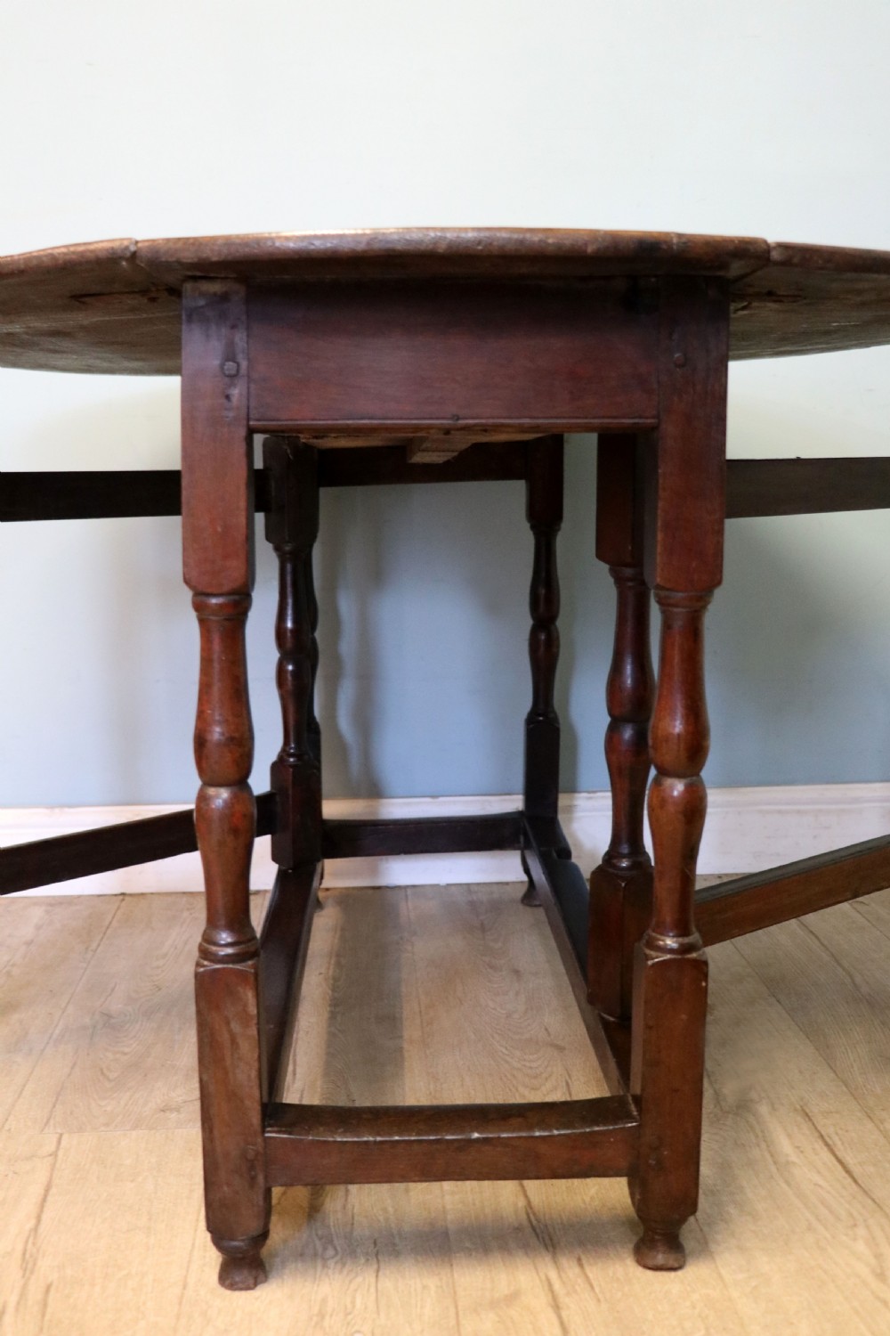 A lovely 18th century English oak drop leaf dining table.  View XVIII