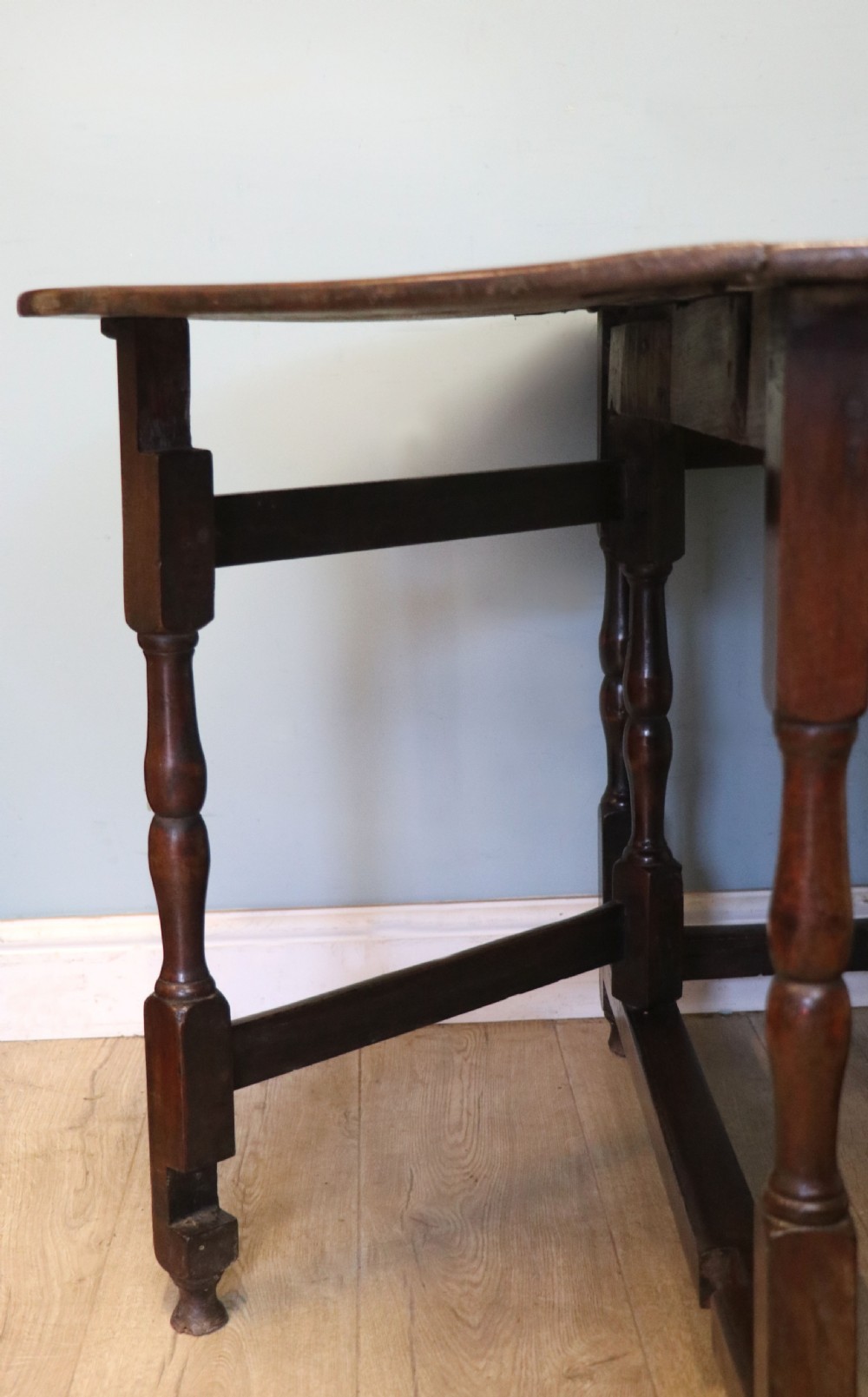 A lovely 18th century English oak drop leaf dining table.  View XIX